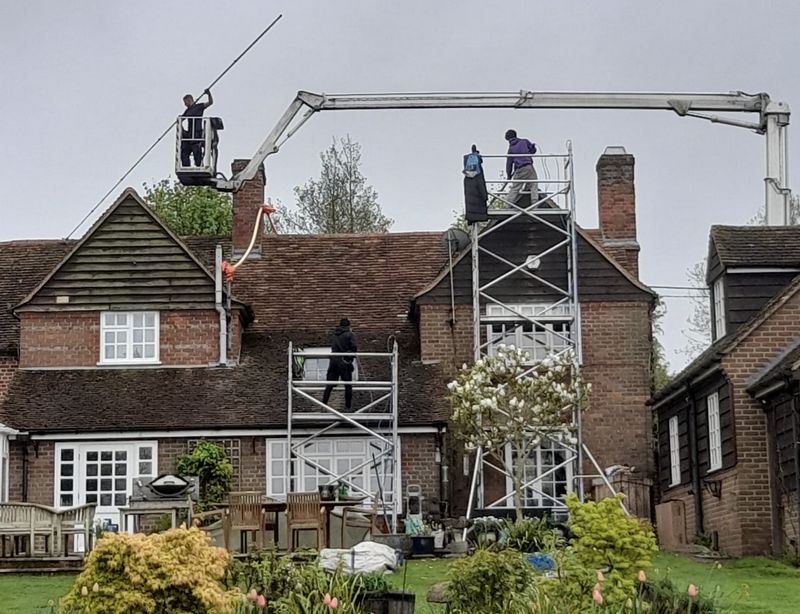 The Roof Moss Cleaners using cherry picker and scaffolding to clean roof safely and professionally in Letchworth Garden City, Hertfordshire